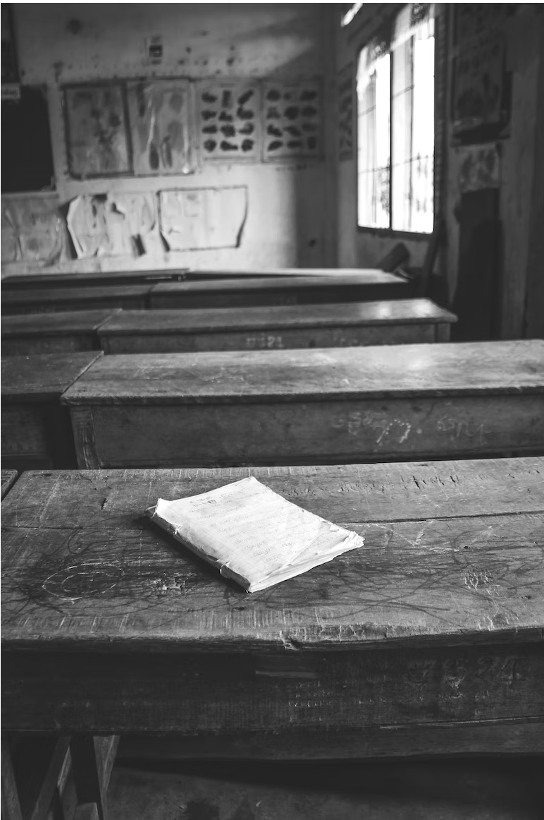 greyscale school room with book on desk